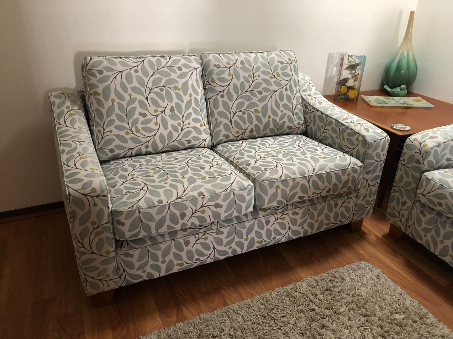 Patterned sofa in a living room setting with a wooden table and decor items. This is the macquarie range by Parker furniture. ParkerFurniture for Sale in Sydney. Ex Parker People™