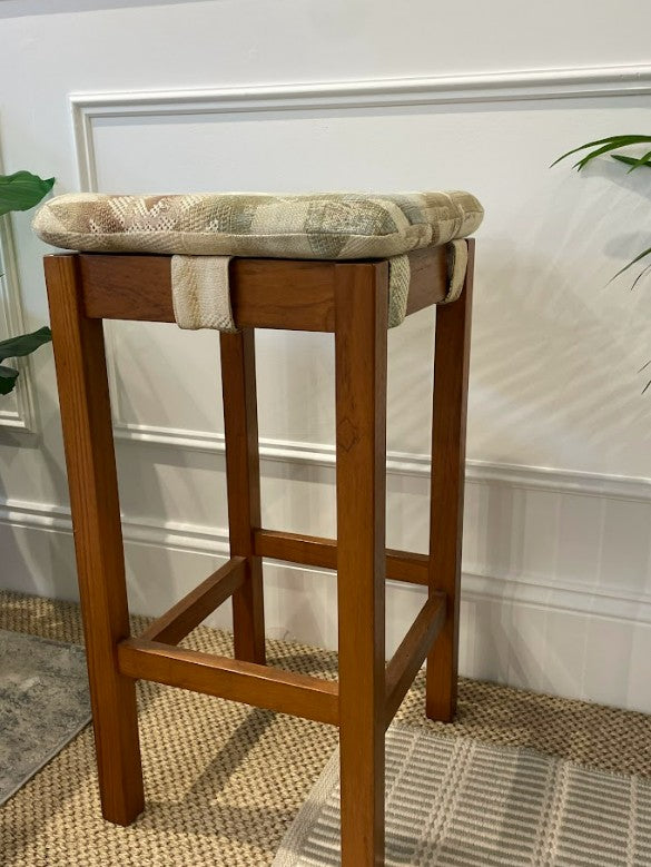 Chiswell bar stool with a cushioned seat against a white wall. Restored by the Ex Parker People™ & available for sale online or at Parker showroom in Willoughby.