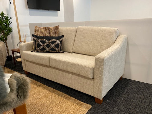Beige Parker furniture sofa with decorative pillows in a room setting. Fully restored and available for purchase by the Ex Parker People™.