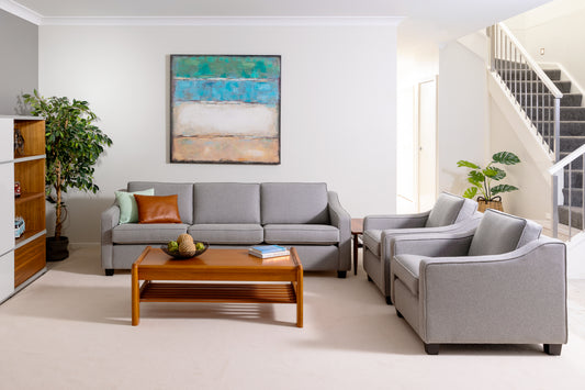 Modern living room with gray sectional sofa, wooden coffee table, and abstract painting on wall. This is the Macquarie range by Parker Furniture. Available for Sale Online, custom made to order. Ex Parker People™