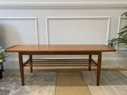 Vintage Parker 126 rectangular coffee table with lower storage rack and sculpted edges. Available for sale.