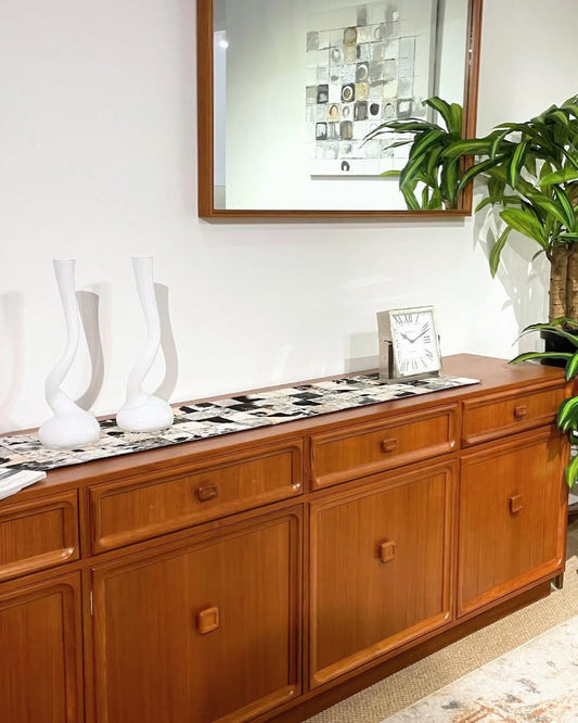 Wooden Parker Furniture sideboard, Teak, Model 26, with decorative items in a room setting.