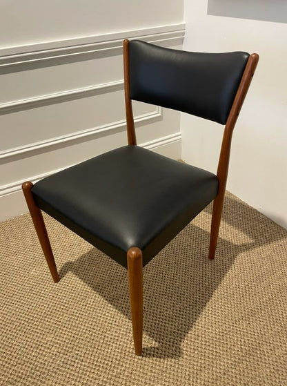 Parker Chair, Model 97,  with black leather seat and backrest on a carpeted floor. Parker Furniture For Sale in Sydney.
