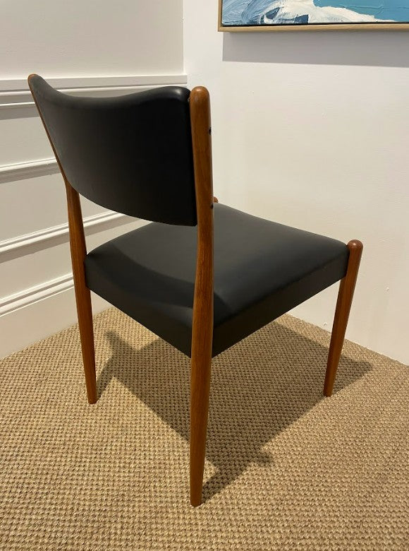 Parker 97 Chair with Black leather with wooden legs on a textured floor. Parker Furniture For Sale In Willoughby.