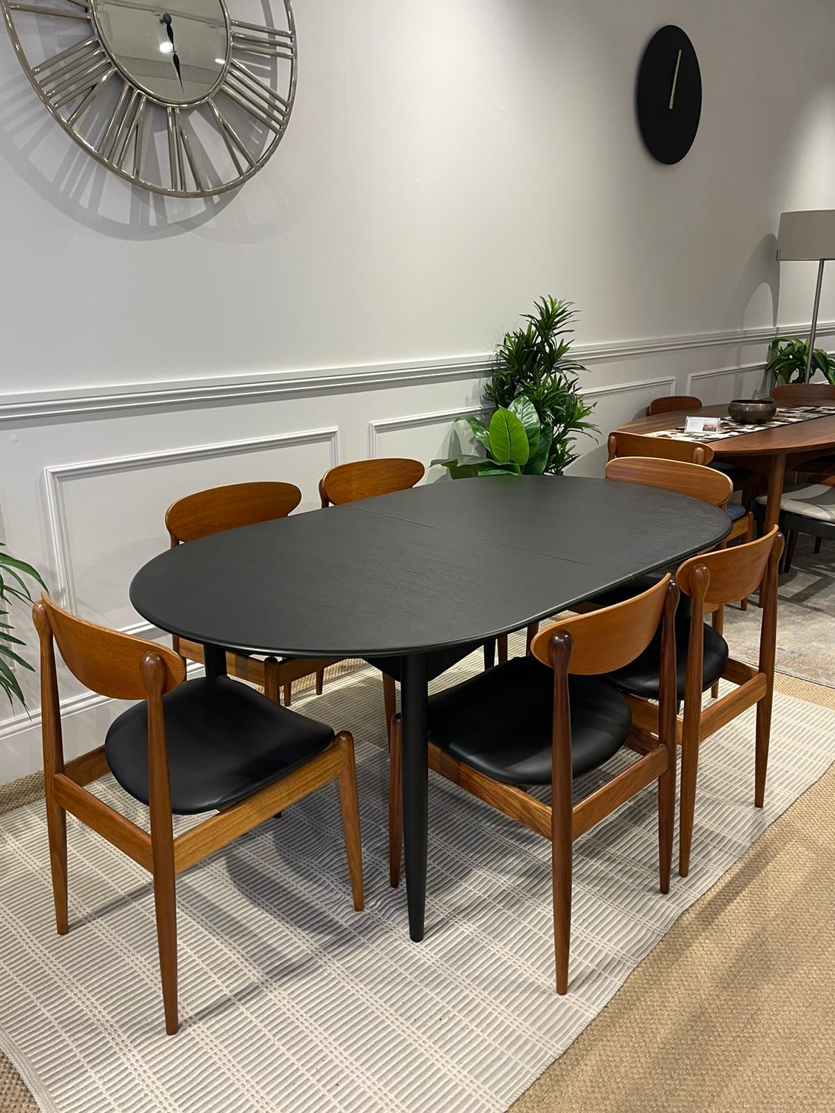 Restored Parker 92 Dining Table stained black with matching Parker 107 dining chairs. Covesmore Solutions