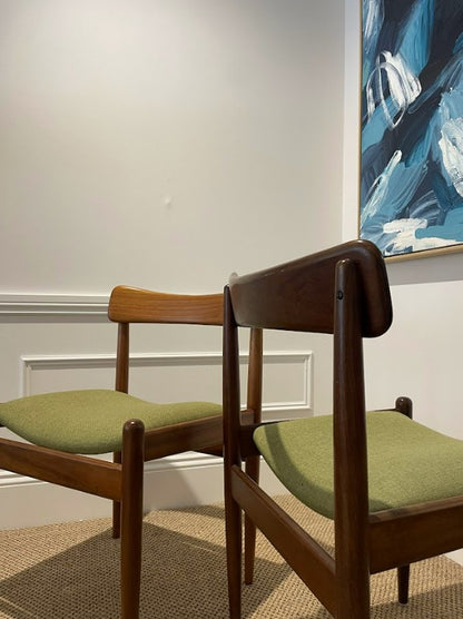Two Parker wooden chairs with green cushions in a room with a painting on the wall. Full restoration by the Ex Parker People™