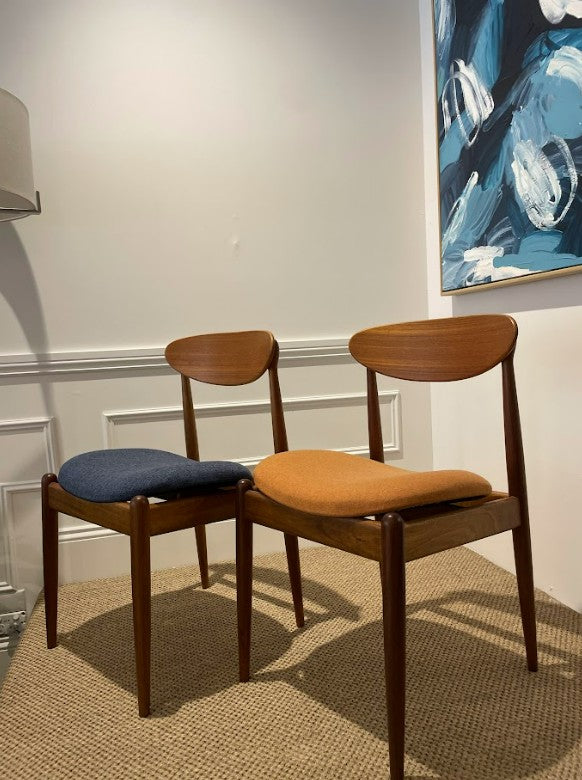 Set of Parker Furniture dining chairs, model 107, with cushioned seats in a room with abstract art on the wall. Available for Sale at Willoughby in any materials.