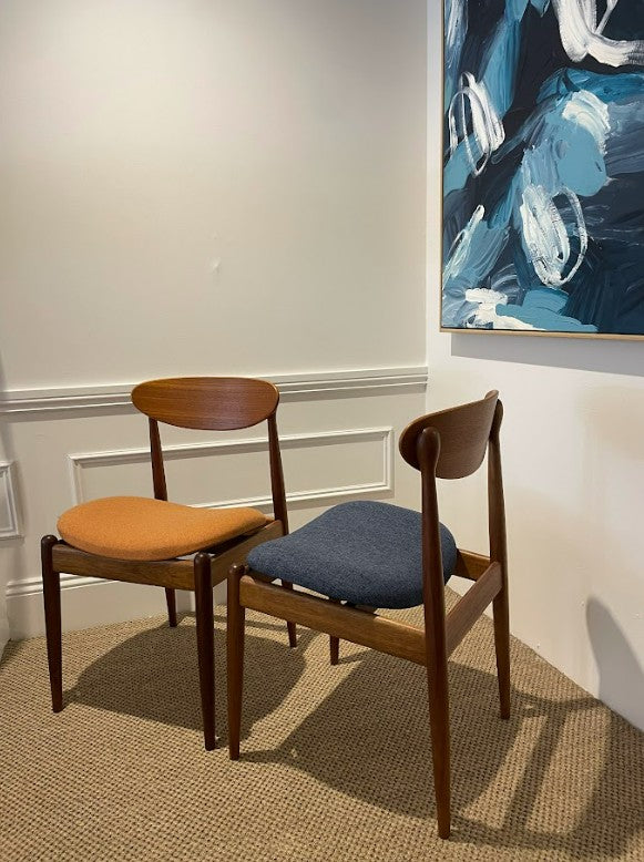 Parker Furniture set of Parker dining chairs, model 107, with cushioned seats in a room with abstract art on the wall. Available for Sale at Willoughby or Online.
