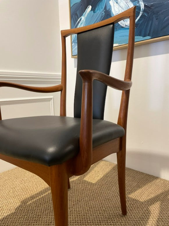 Parker Carver chair, Model 61,with black leather seat and backrest in a room with a painting on the wall. Parker Furniture For Sale.