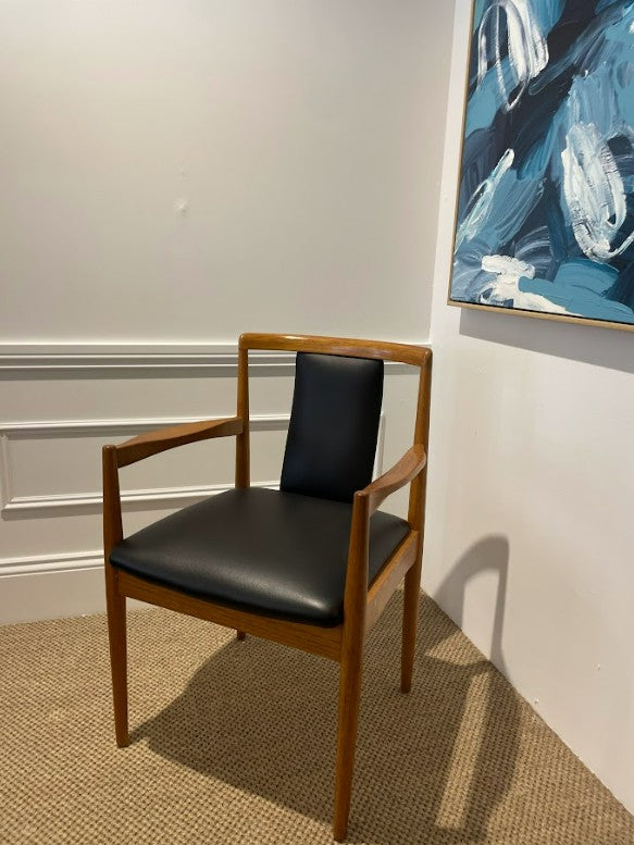Parker 88 Wooden chair with black leather in a room with abstract art on the wall. This Parker furniture is for sale.