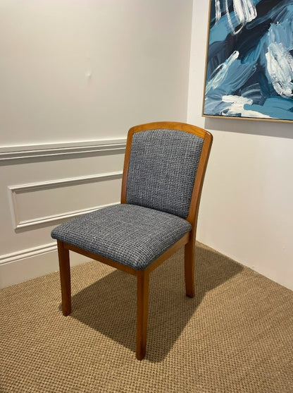 Parker Chair, model 92, with wooden frame and gray cushioned seat in a room with a painting on the wall. Available online or in Willoughby at Parker furniture showroom.
