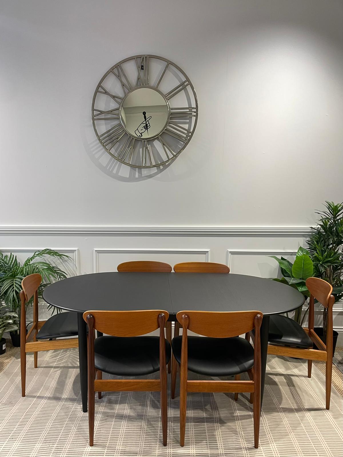 Parker Dining room with a round table and wooden chairs, featuring a large wall clock. Full Refurbishment by the Ex Parker People™ in Sydney.