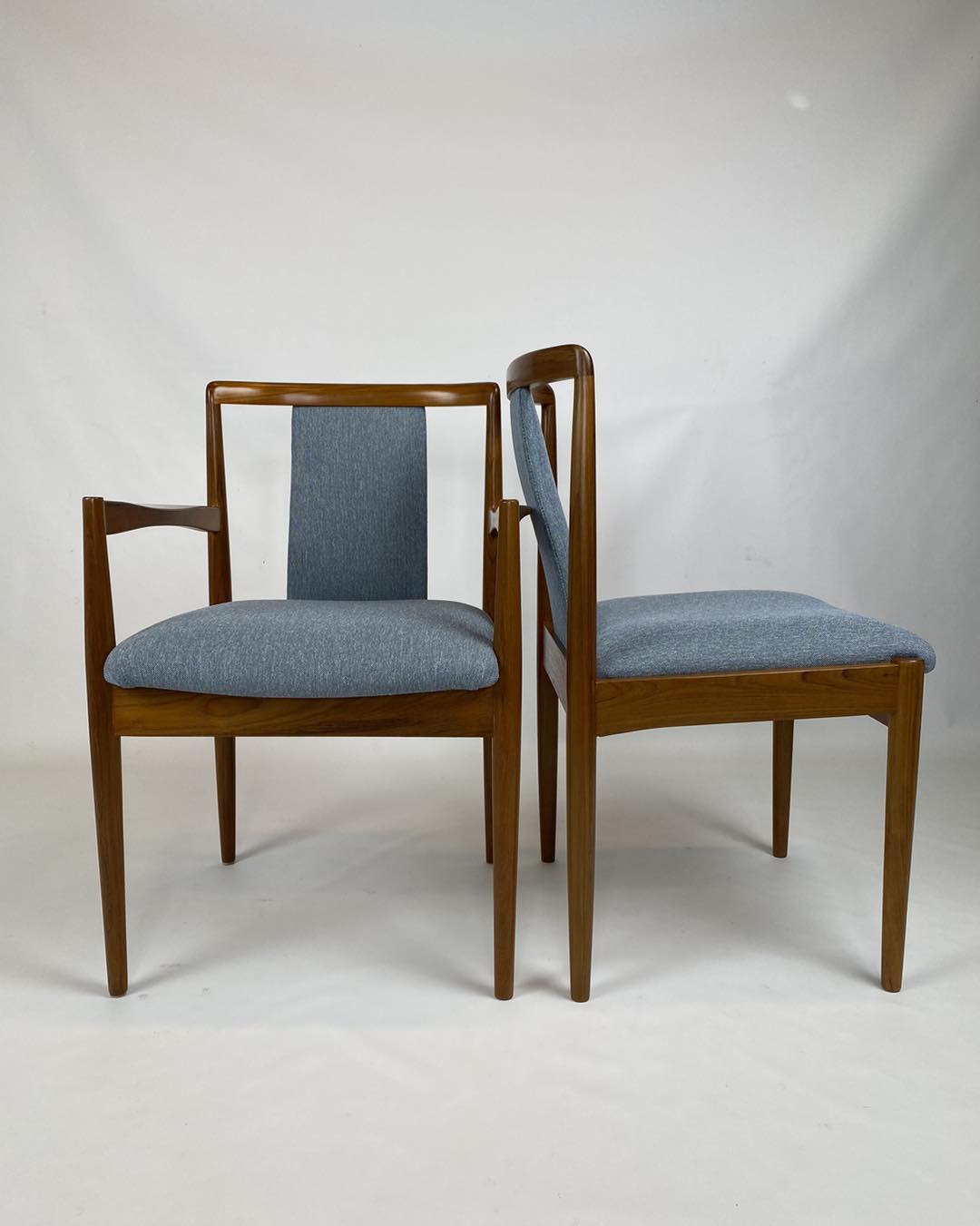 Pair of Parker chairs, Model 88 & 89, with blue upholstered seats on a white background. Parker Furniture restored by Covesmore. Available online or in Willoughby at Parker furniture showroom.
