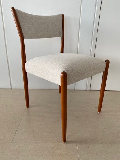 Parker Chair, Model 97,  with wooden legs and white cushioned seat against a white wall. Available for Sale Online and at Willoughby showroom.