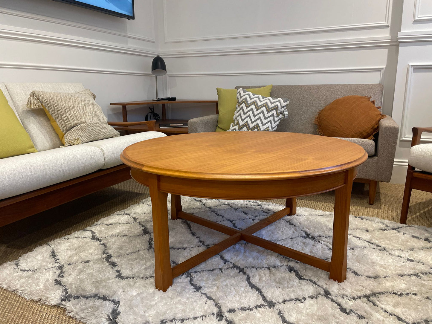 Parker wooden coffee table in a living room with a sofa and decorative pillows. Part of parker furniture for sale in Sydney showroom.