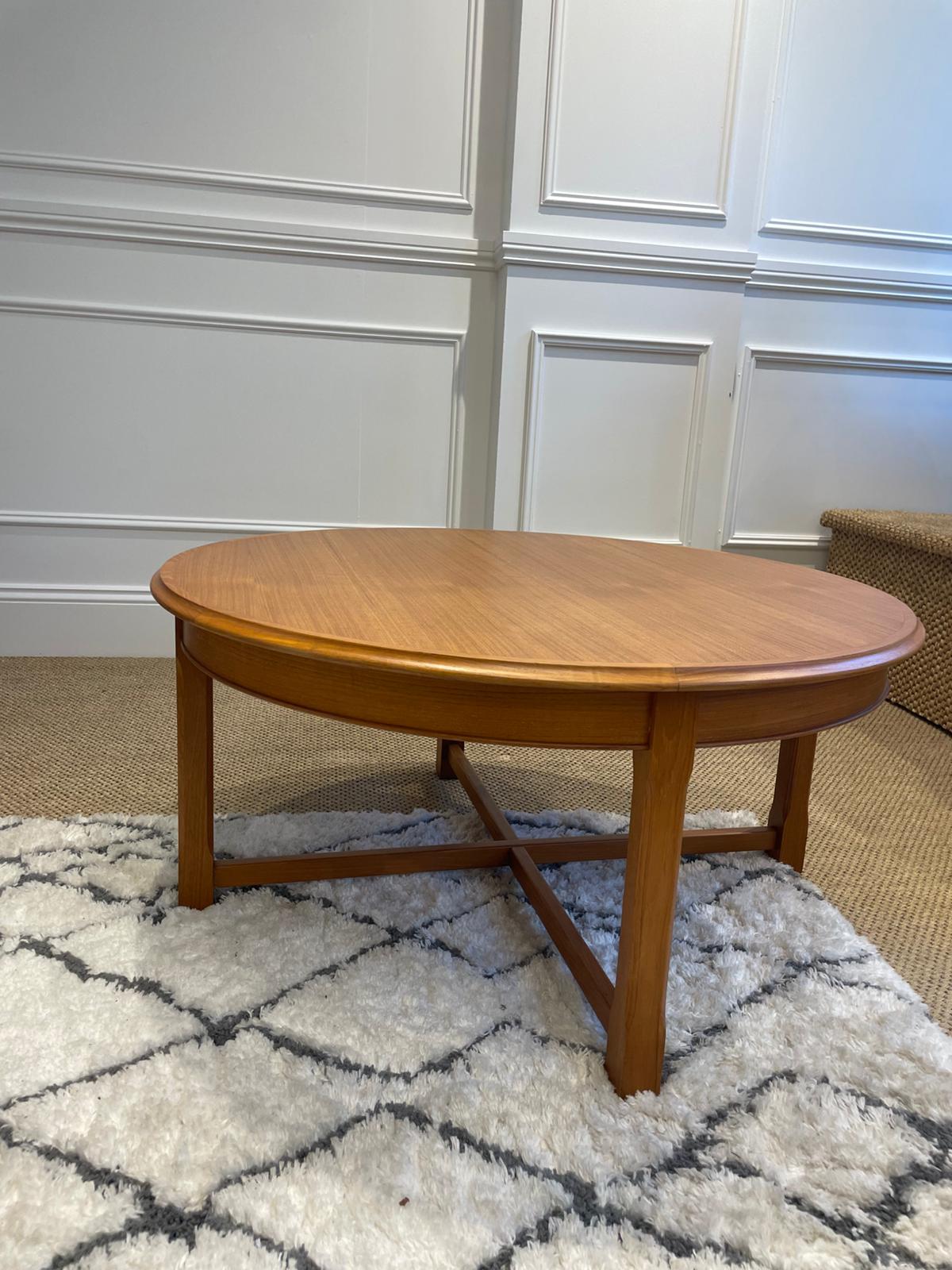 Wooden teak coffee table by Parker furniture in a room with wainscoting and a patterned rug. Restoration by Covesmore.
