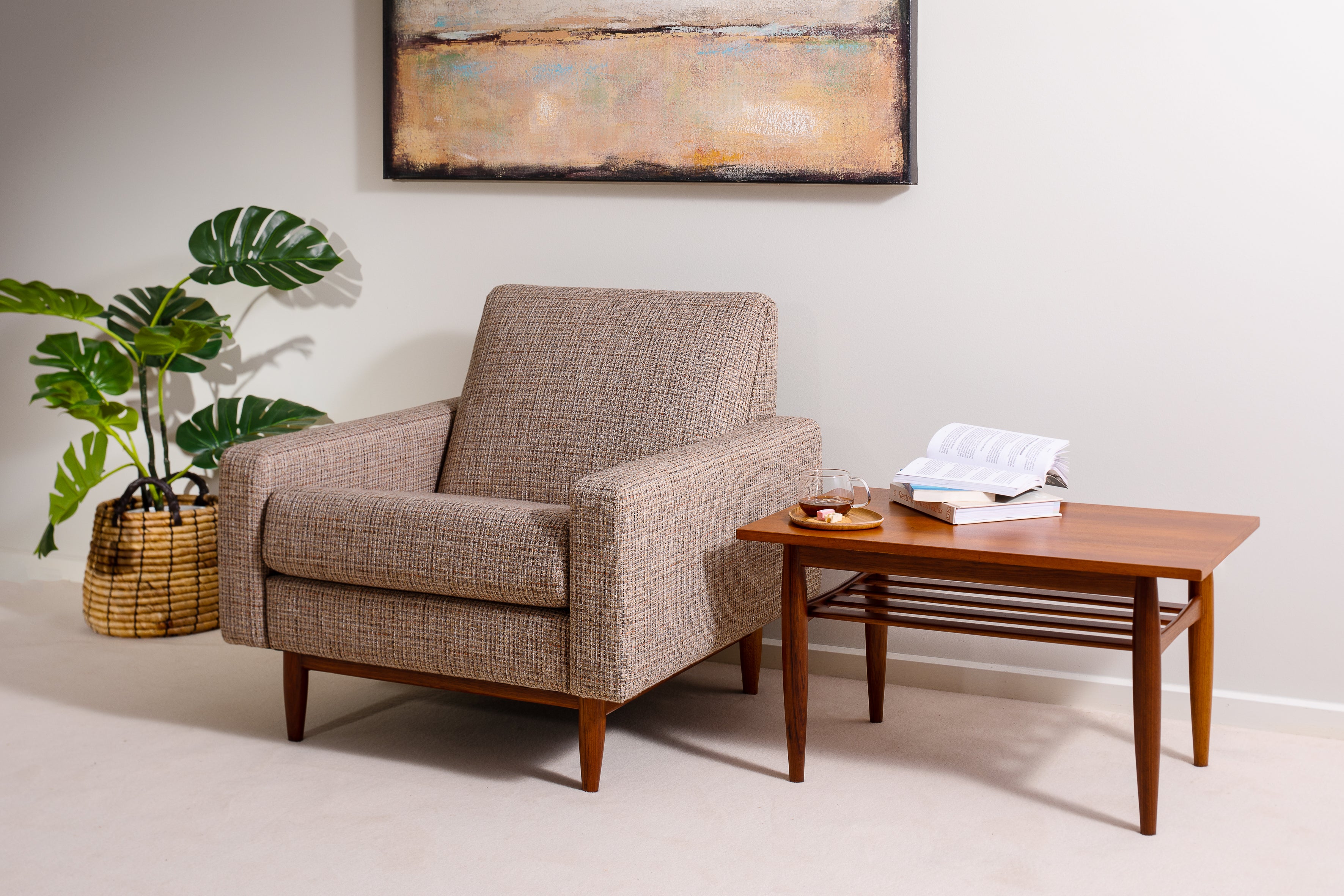 The Parker armchair, model 131, fully reupholstered in a Mokum fabric, wood fully stripped and repolished, next to a coffee table by Parker furniture. Parker furniture for sale in Sydney.
