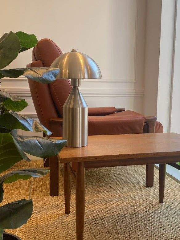 Modern interior with a mid century coffee table, silver lamp, and Tessa armchair. All fully restored by the Ex Parker People™. Available on site or online. Located in NSW, Sydney