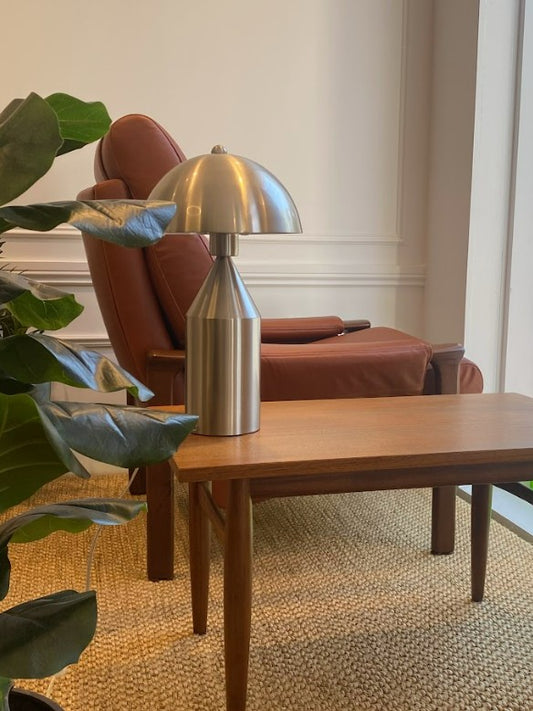 Modern interior with a mid century coffee table, silver lamp, and Tessa armchair. All fully restored by the Ex Parker People™. Available on site or online. Located in NSW, Sydney