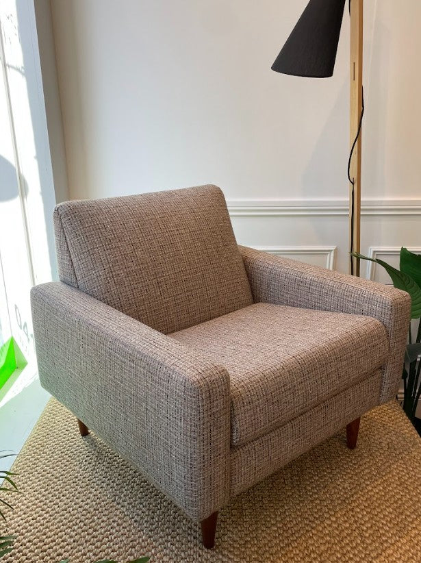 Brown Parker armchair in a room with a lamp and window. Parker furniture available in Sydney showroom.