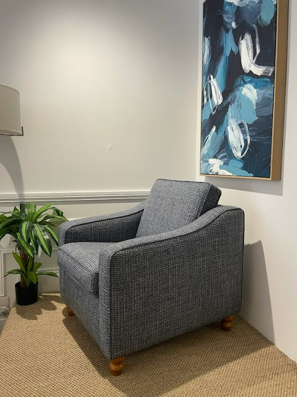 Gray armchair in a room with a abstract painting on the wall. This armchair is part of the macquarie range by Parker furniture, available for viewing in Willoughby.