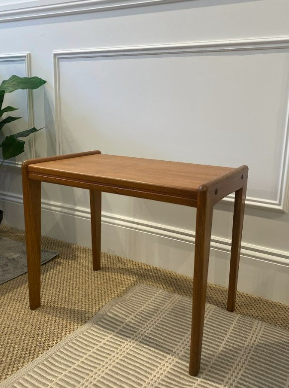 Mid-century table in a room with a plant and decorative wall molding. Refurbishment by the Ex Parker People™
