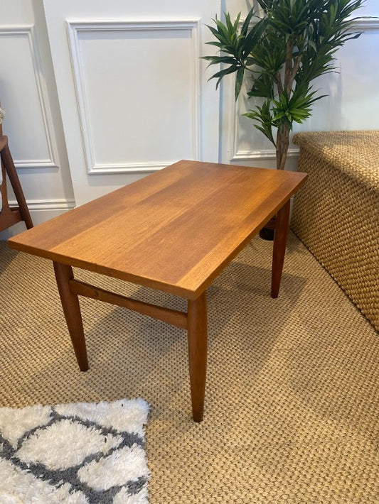 Mid Century Wooden coffee table in a room with a plant and rug. Furniture refurbishment specialist. Ex Parker People™