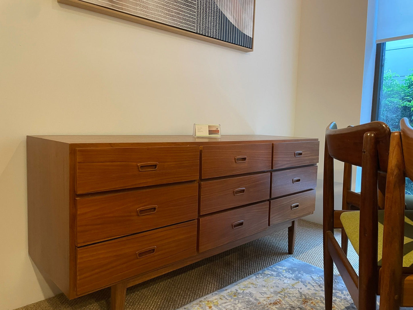 Parker Wooden dresser with multiple drawers in a room with a chair and window. Available in Sydney.