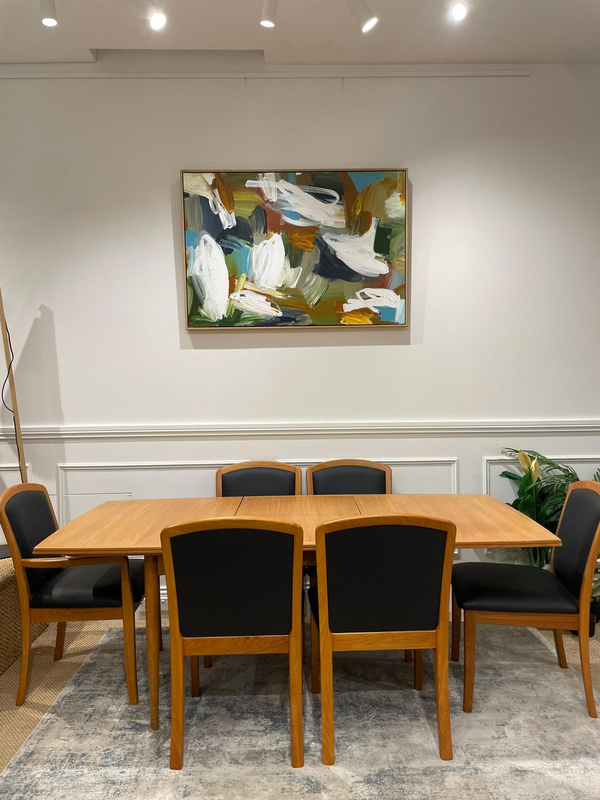 Parker Furniture for sale in Willoughby Showroom, features a Dining room with wooden table and chairs, abstract painting on the wall. Available in Willoughby at Parker furniture showroom.
